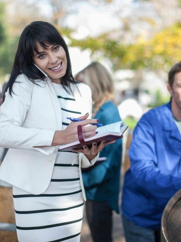 wine-saleswoman-with-group-of-clients-outdoors-and-wine-worker-with-barrel.jpg